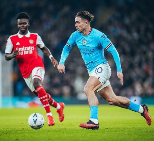 Jack Grealish playing for Manchester City against Bukayo Saka of Arsenal in the FA Cup Fourth Round