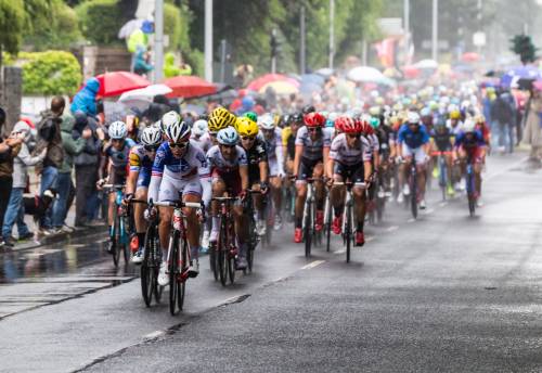 Tour de France peloton in rainy weather.